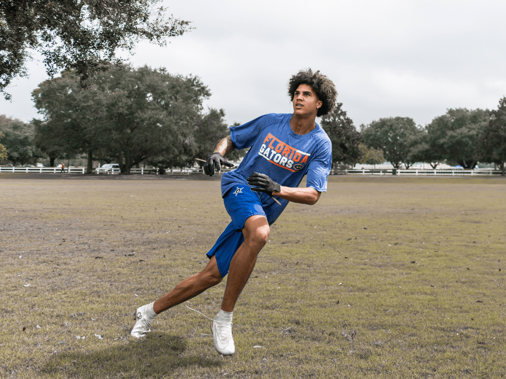 Position your body on the football's direction to get better at catching football