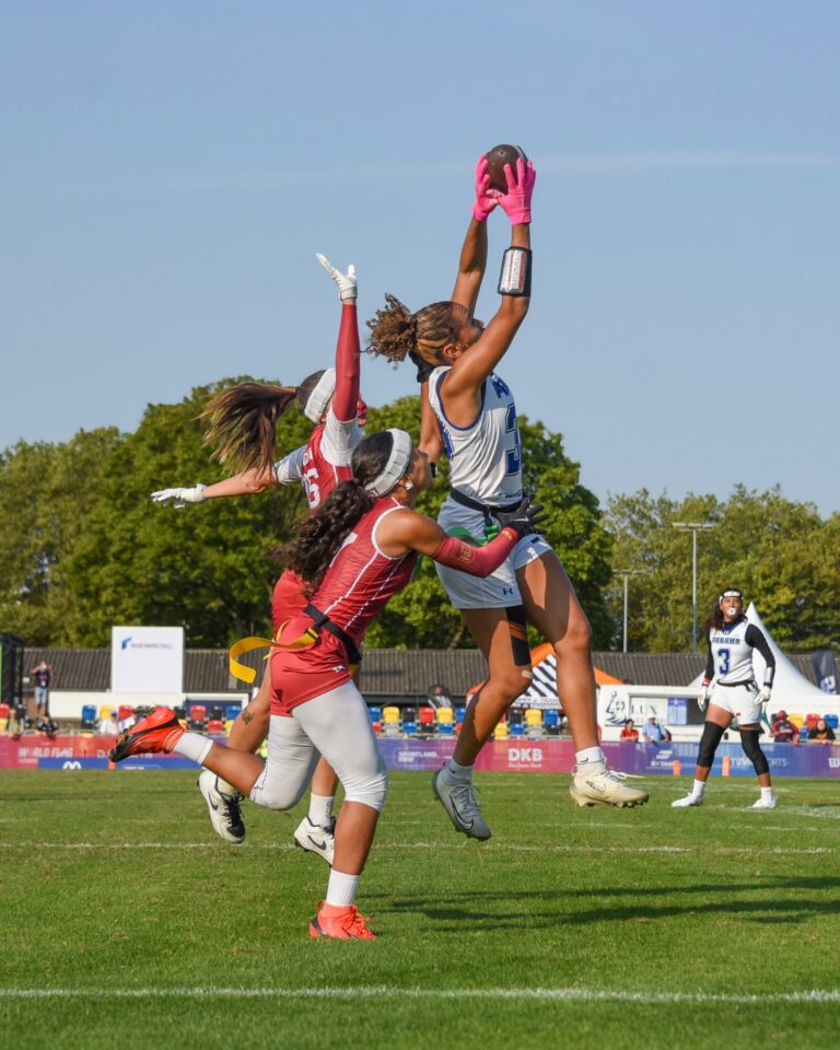 Maria Baloy of Panama catches the ball over two Spanish defenders at the 2026 flag football world championships