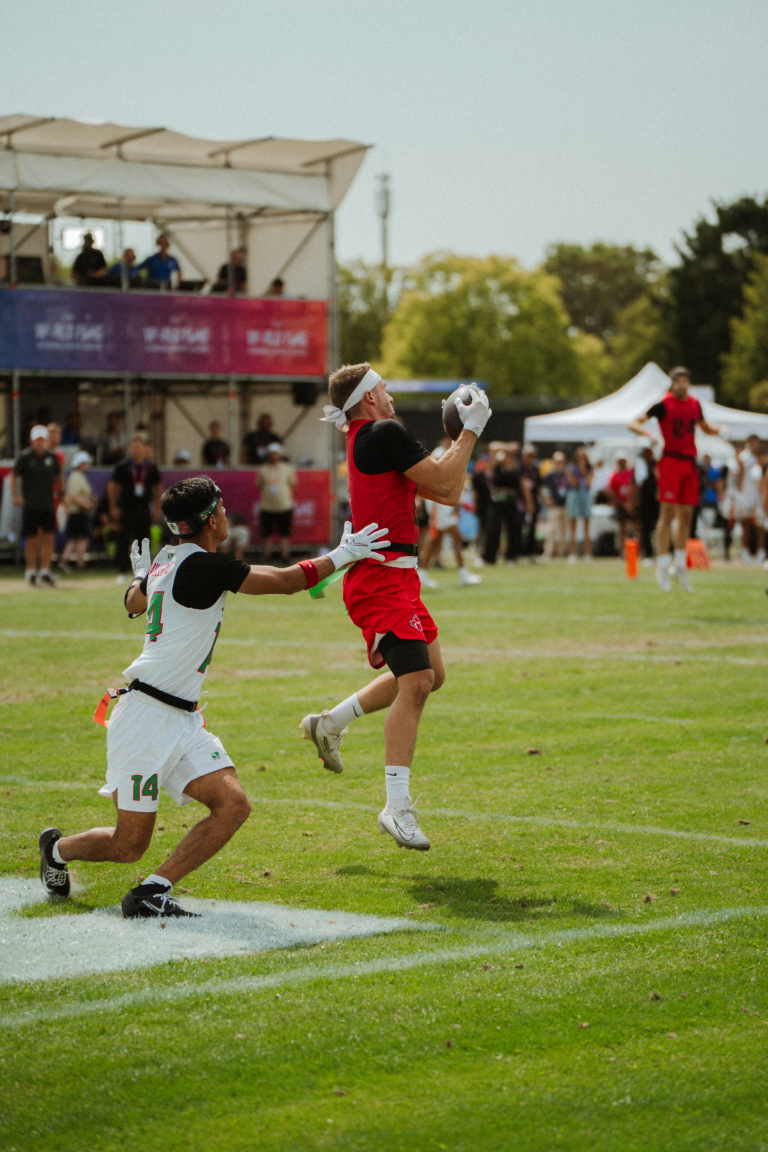 Guillaume Beland of Team Canada intercepts on the final play of the bronze medal game at the 2026 flag football world championships, wearing Invictus gloves